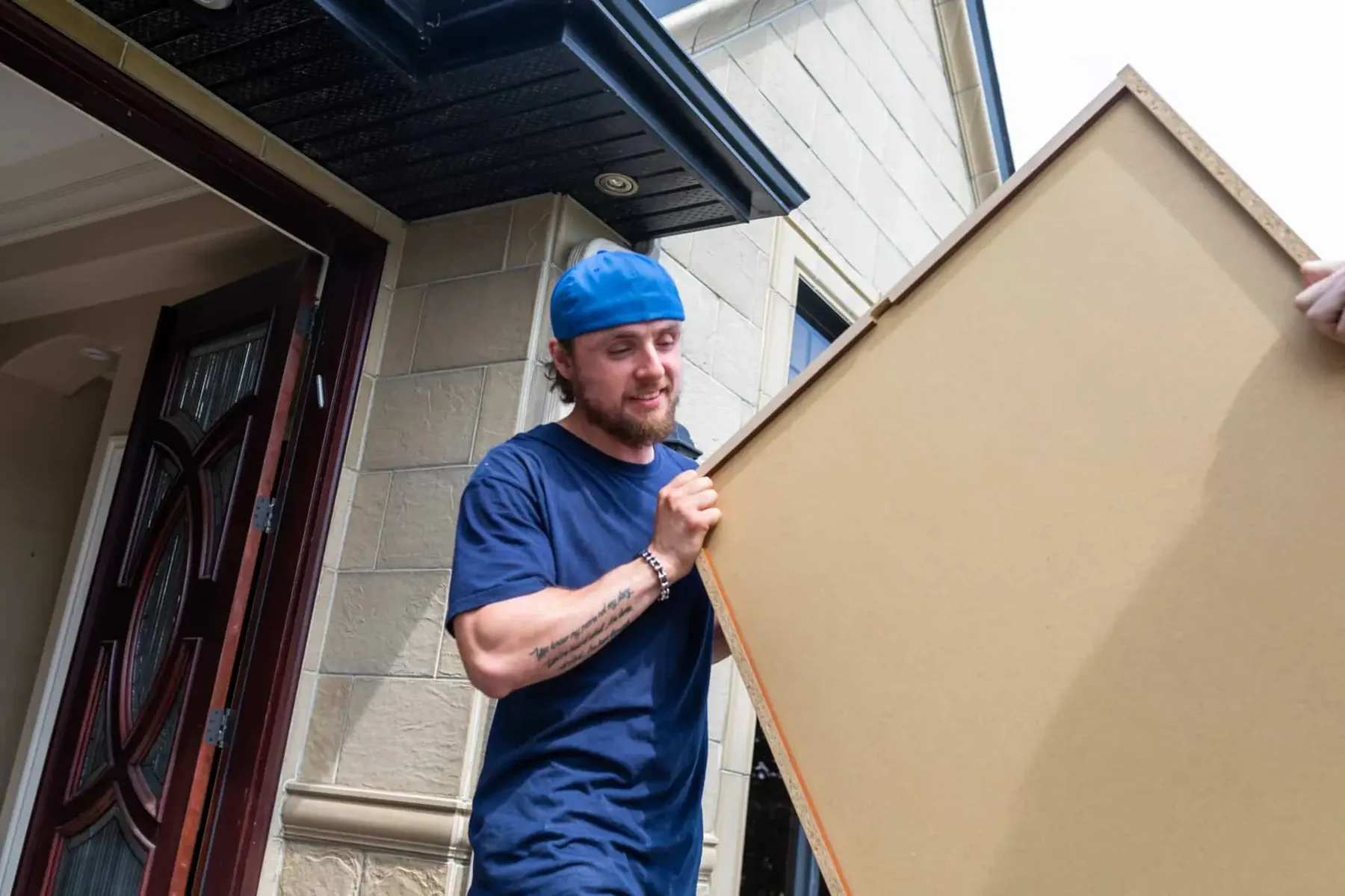 Mover carrying furniture panel during a residential move